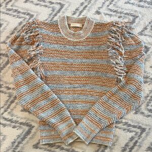 Striped knit sweater with fringe detail and puffed sleeves